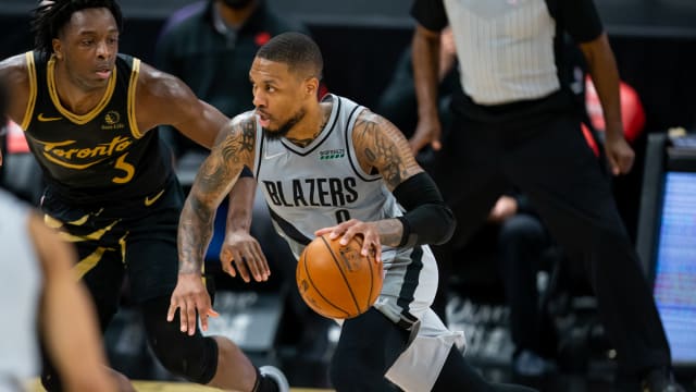 Portland Trail Blazers guard Damian Lillard (0) drives past Toronto Raptors forward OG Anunoby (3) 